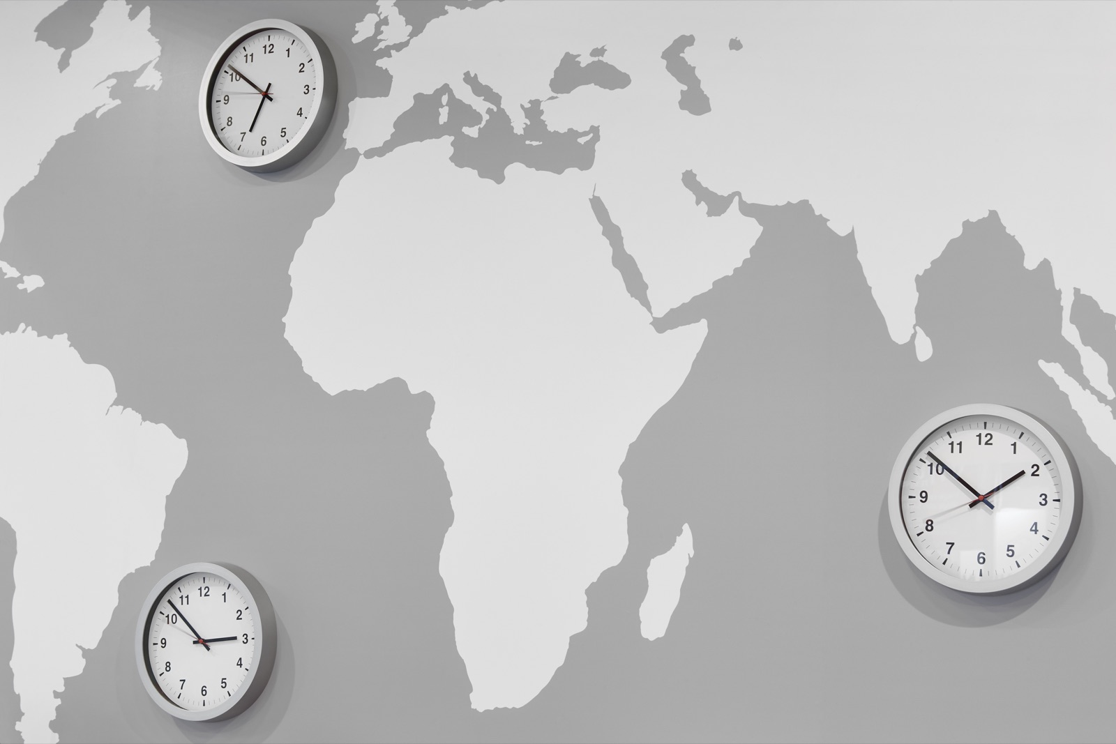 Time zone clocks on a world map illustrating nearshore vs offshore outsourcing