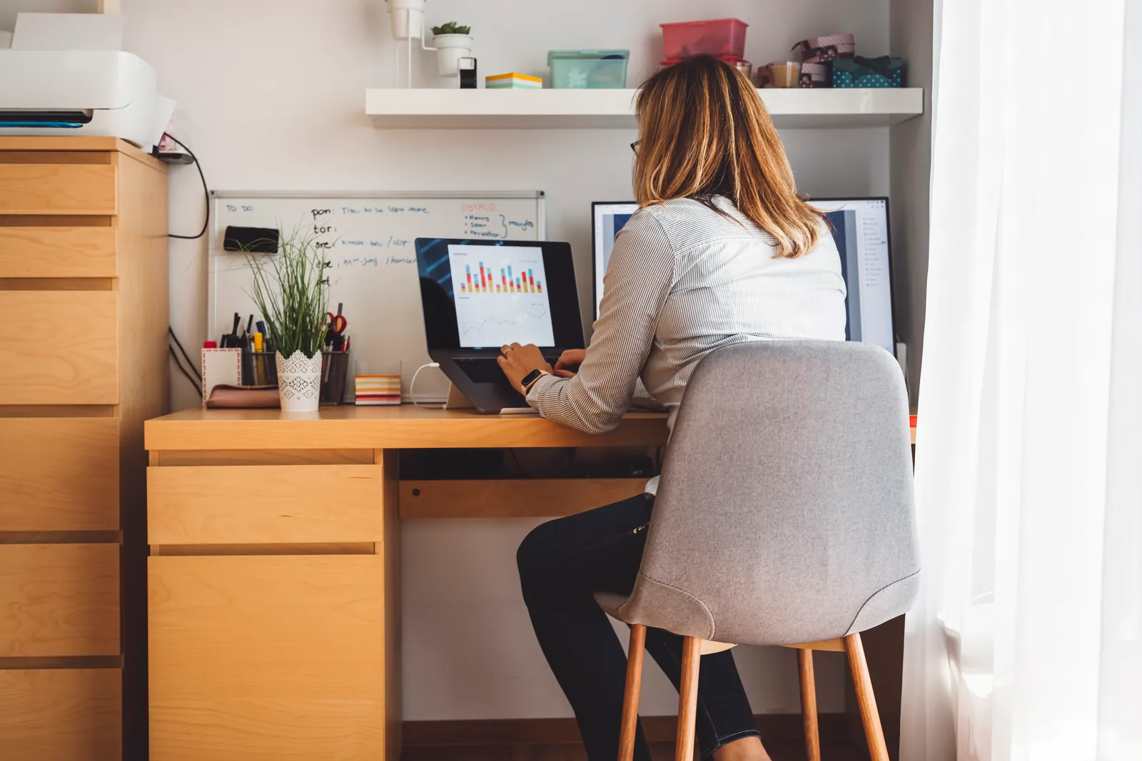 Woman working from home as a remote virtual assistant from Latin America